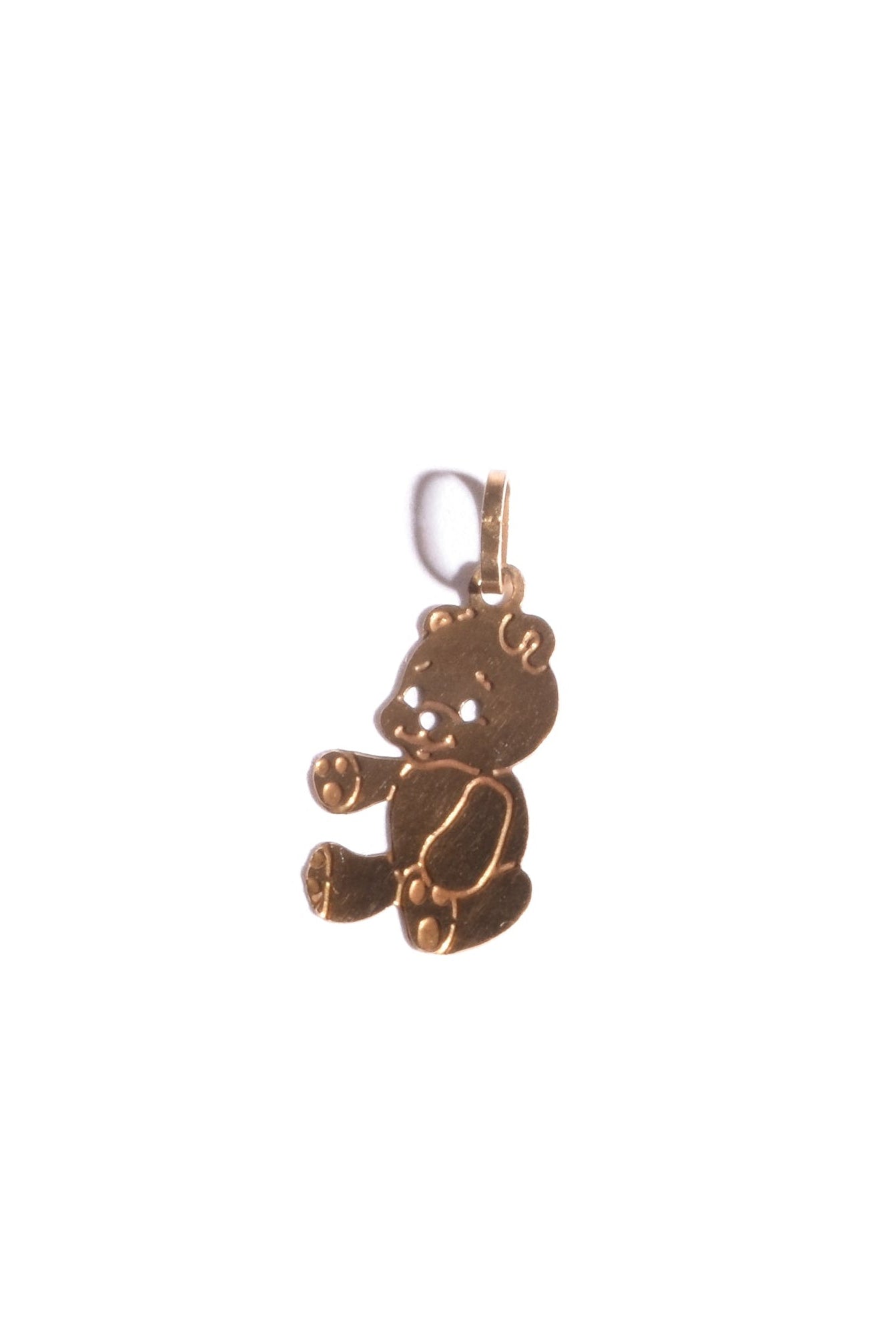 Gold teddy bear pendant on a white background