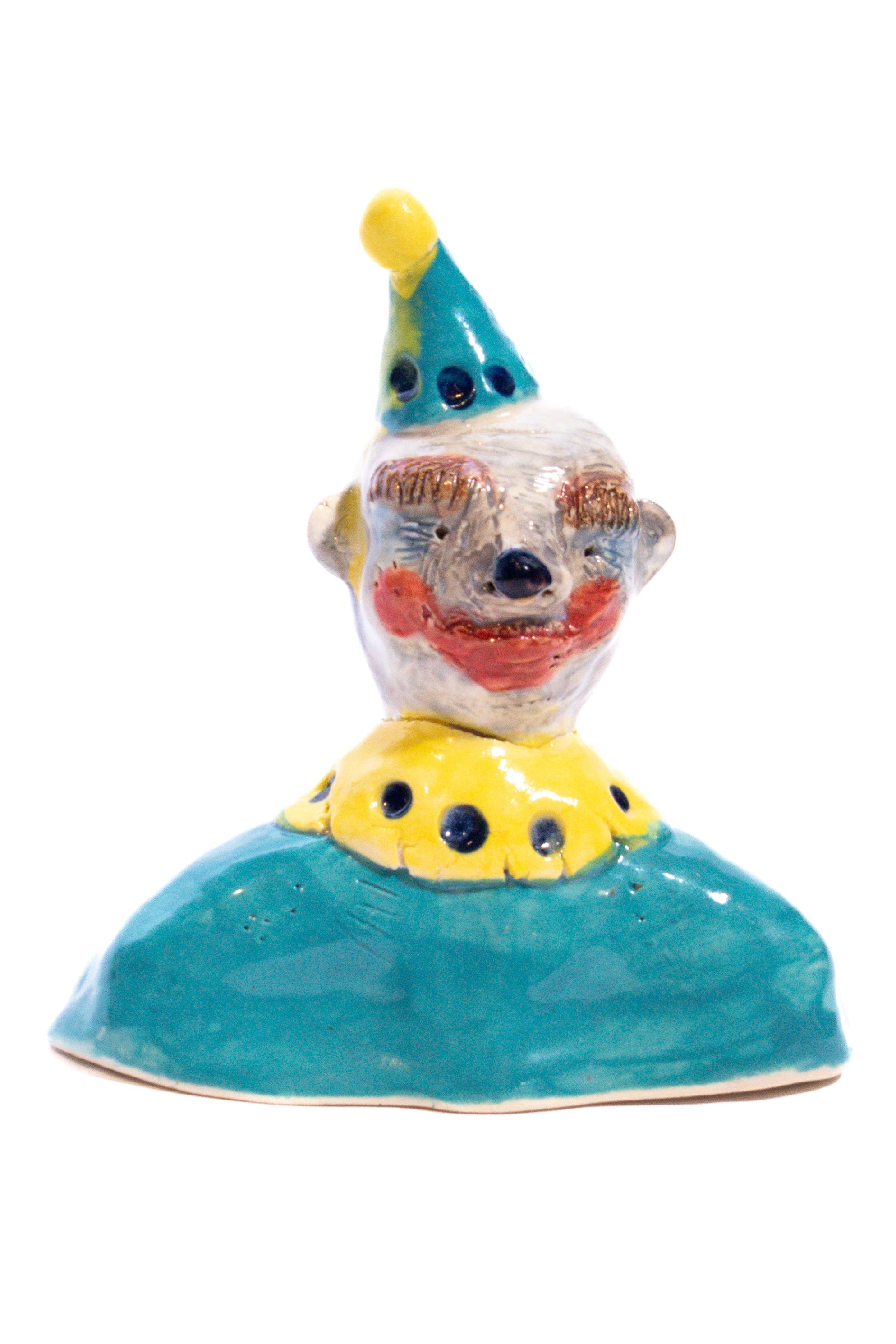 Ceramic clown figurine with a blue hat and yellow shirt on a white background